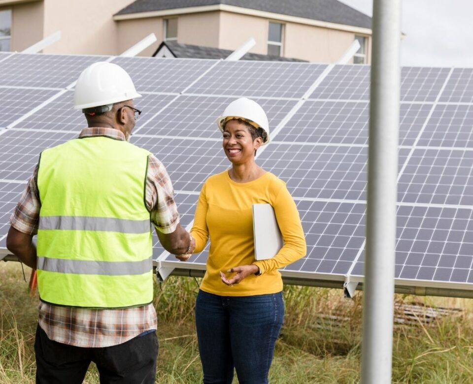 Renewable energy company representative meets with technician